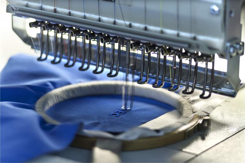 Custom logo embroidery on apparel fabric by Full Speed 100